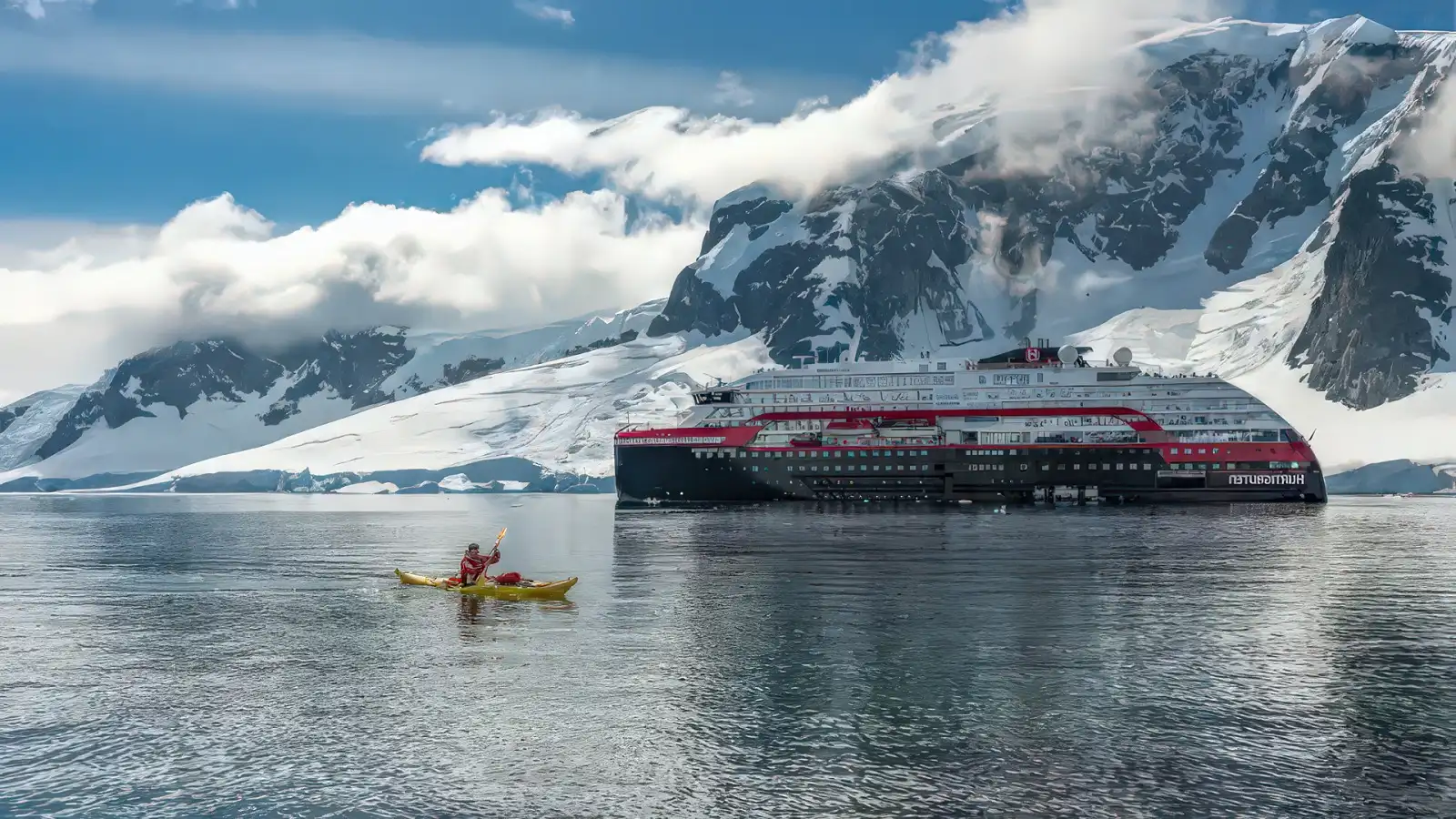 A Hurtigruten expedition ship among Arctic ice and mountains