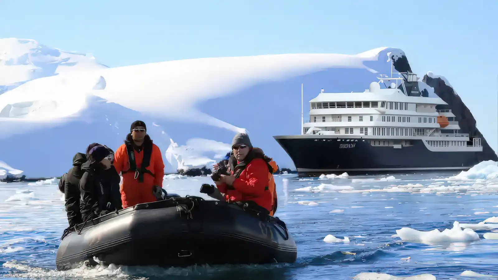 A Poseidon Expeditions ship anchored beside towering polar ice