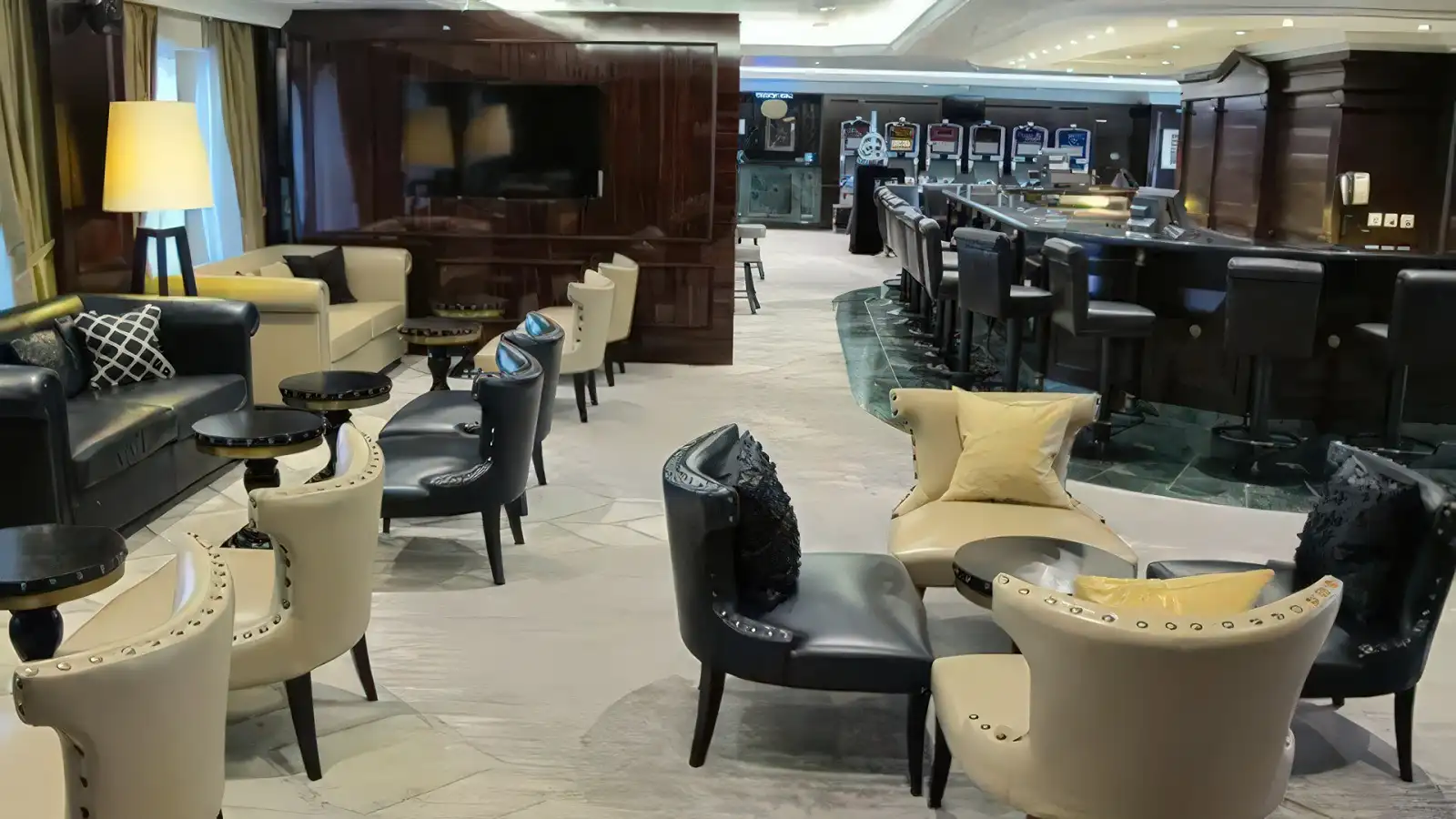 A relaxed Azamara lounge with soft lighting and armchairs