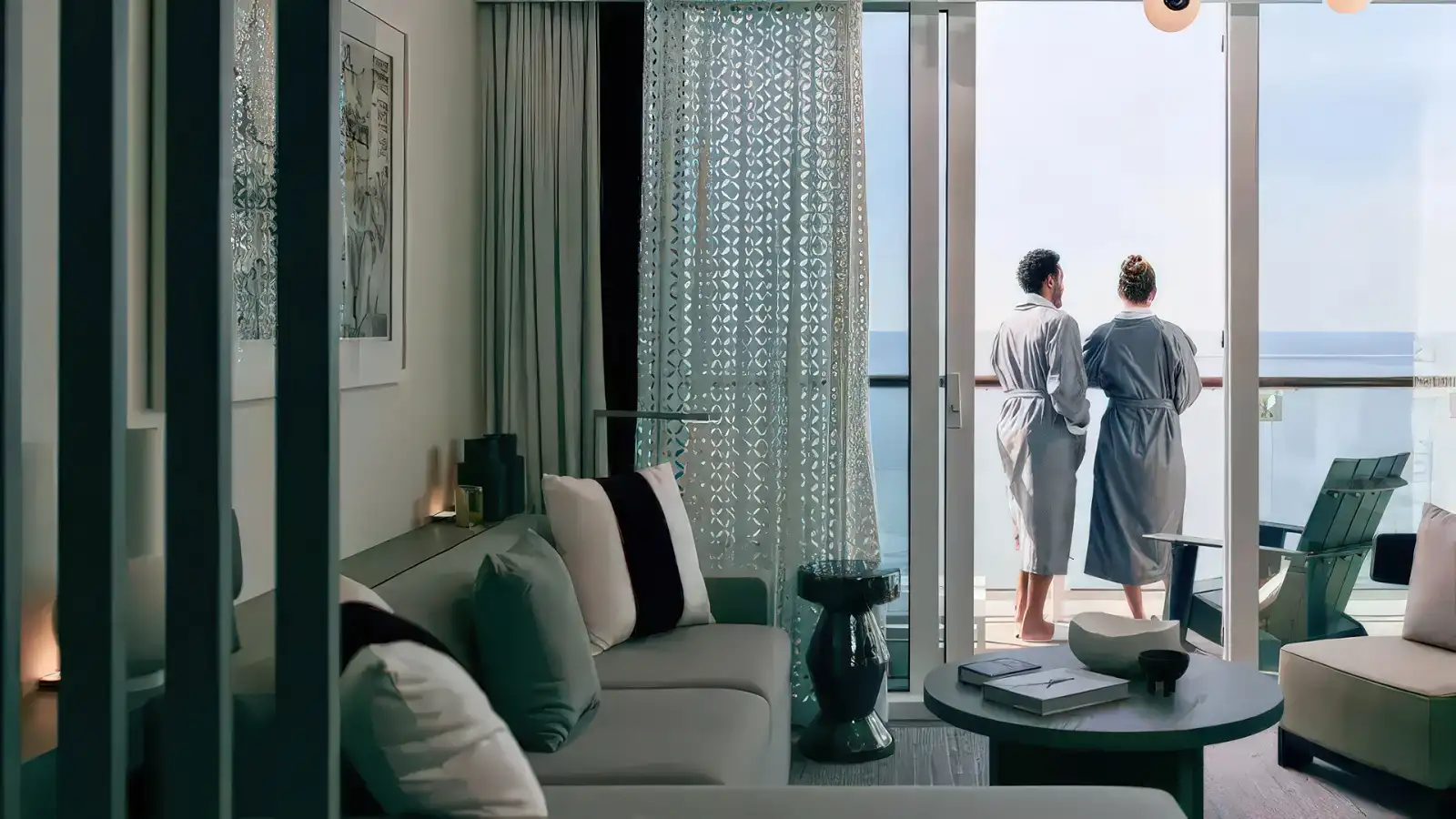 A couple relaxing on a private Celebrity stateroom balcony at sea