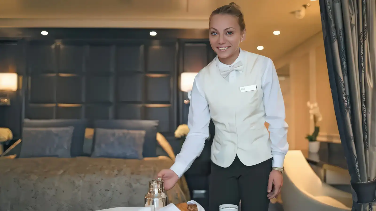A Regent server presenting a plated dish in a dining room