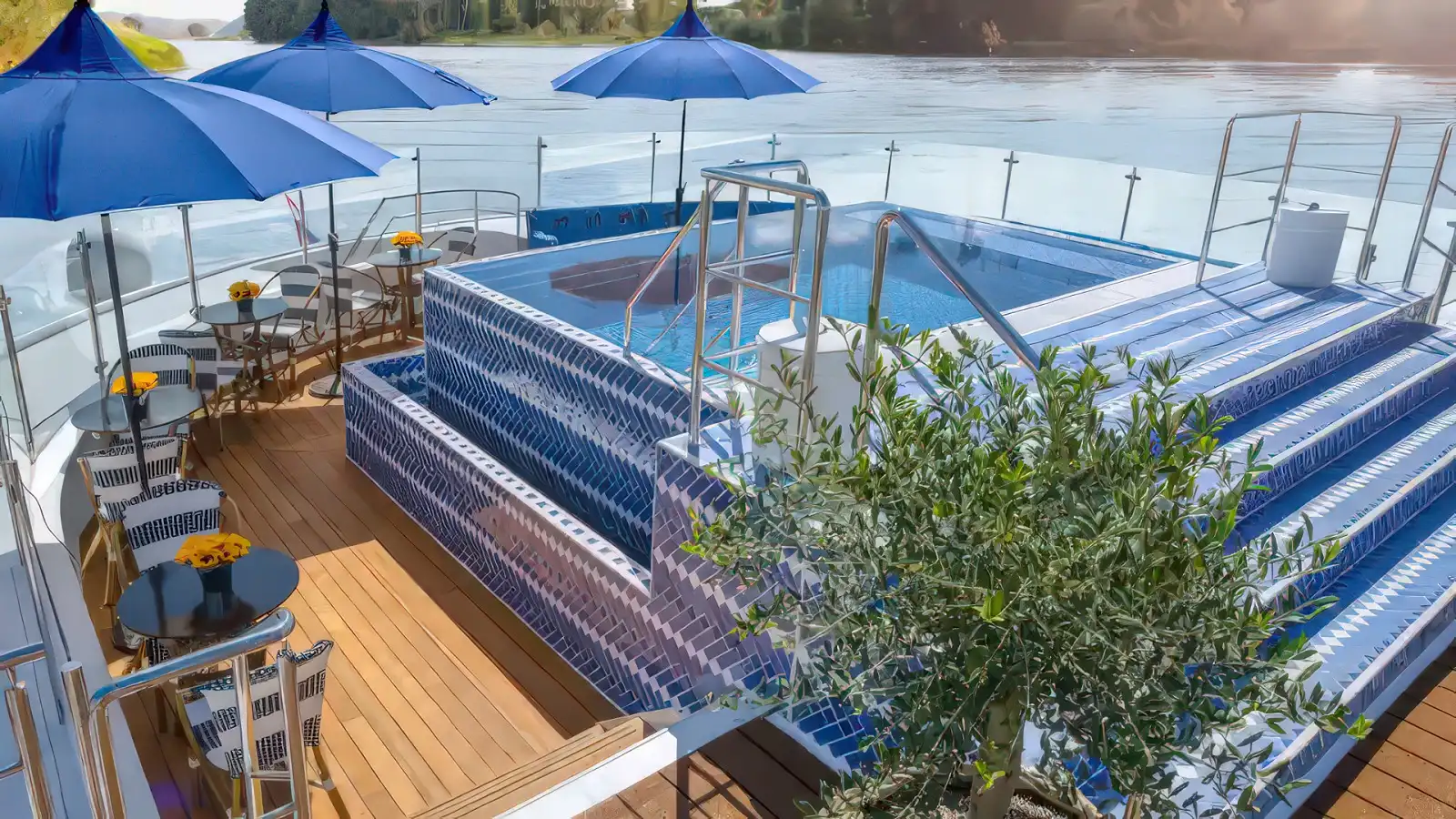 The top-deck pool of a Uniworld Super Ship overlooking a European river