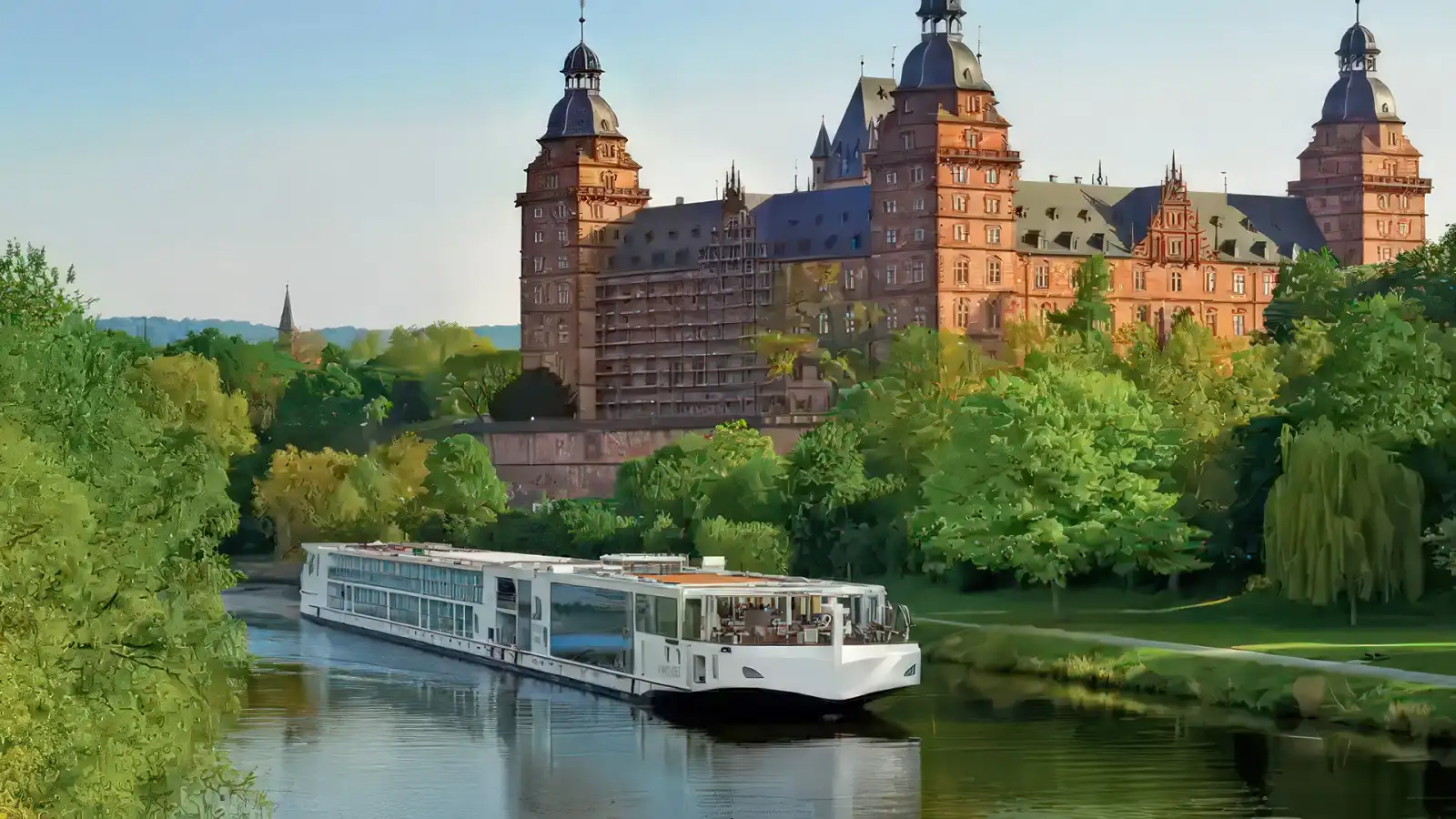 A Viking Longship cruising past a hilltop castle on a European river