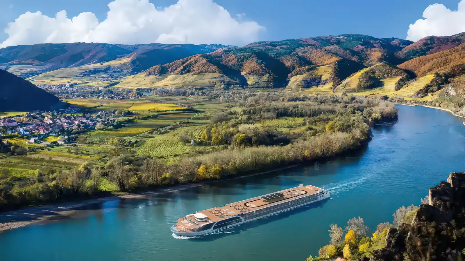 An AmaWaterways river ship rounding a bend on a European river at dusk