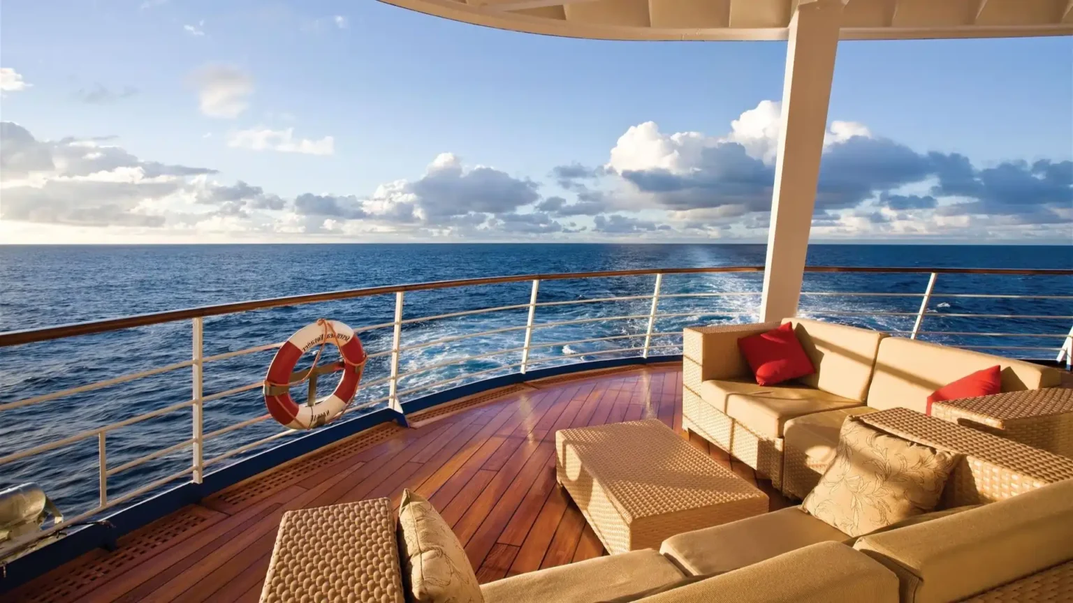 The teak deck of a luxury ship at sea at golden hour